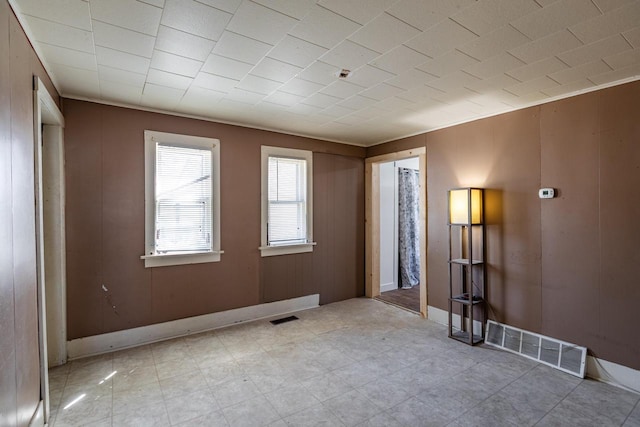 empty room with baseboards and visible vents