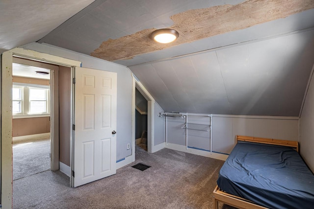 bedroom featuring vaulted ceiling, baseboards, visible vents, and carpet floors