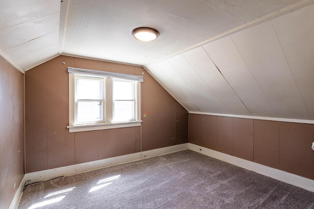 bonus room featuring baseboards, carpet floors, and vaulted ceiling