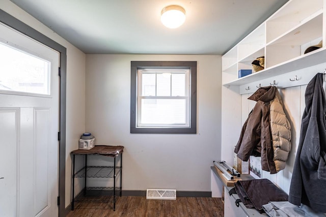 mudroom with baseboards, visible vents, plenty of natural light, and wood finished floors