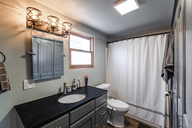full bathroom featuring vanity, toilet, wood finished floors, and shower / bath combo