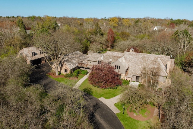 view of subject property featuring a heavily wooded area