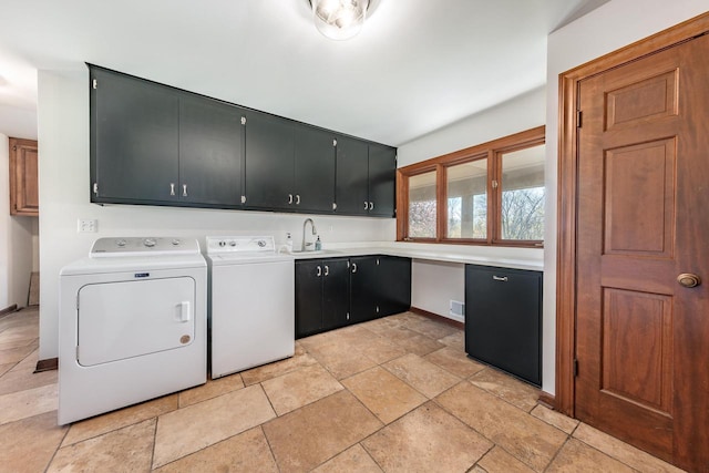 laundry area featuring cabinet space, washer and clothes dryer, baseboards, and light stone finish floors