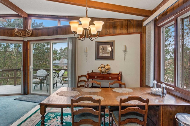1074 E Queens Way, Nekoosa, WI 54457 - dining space featuring beamed ceiling, a notable chandelier, wood walls, and carpet