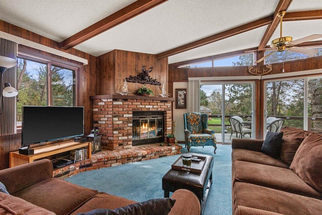 1074 E Queens Way, Nekoosa, WI 54457 - living area featuring ceiling fan, wooden walls, a brick fireplace, and carpet floors