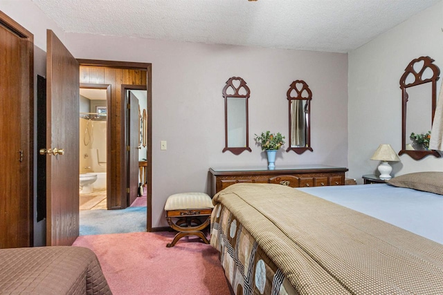 1074 E Queens Way, Nekoosa, WI 54457 - bedroom featuring a textured ceiling, connected bathroom, and carpet