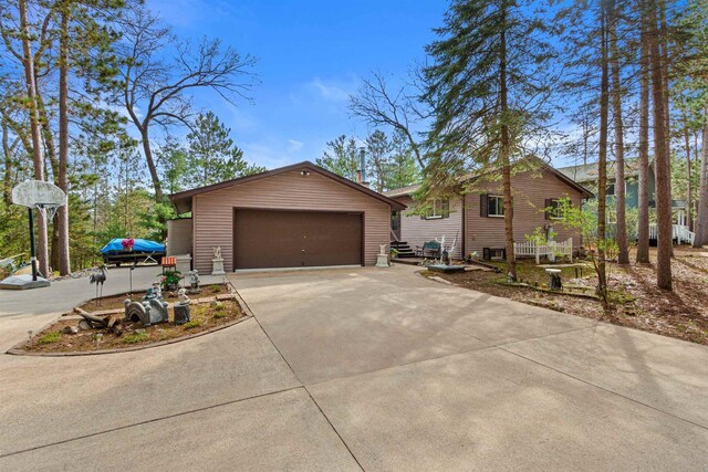 1074 E Queens Way, Nekoosa, WI 54457 - exterior space with an attached garage, an outbuilding, and driveway