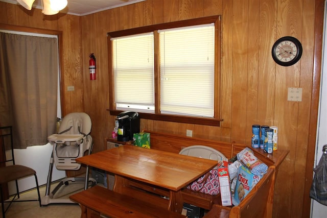 dining space featuring wood walls