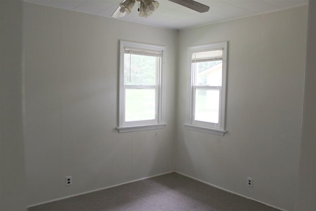 carpeted spare room featuring a ceiling fan