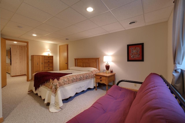 carpeted bedroom featuring a drop ceiling, visible vents, and recessed lighting