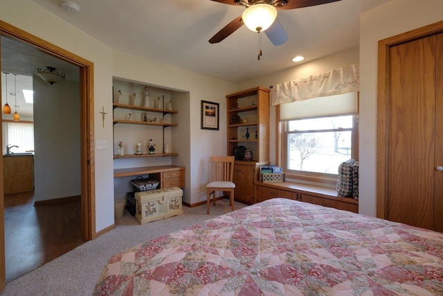 bedroom with carpet, baseboards, a ceiling fan, and multiple windows