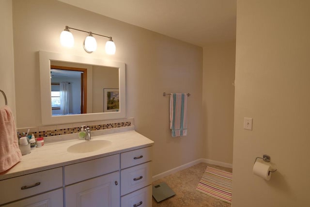 bathroom with backsplash, baseboards, and vanity