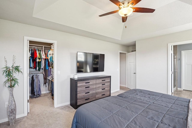 521 Dragon Willow Ln, Middleton, WI 53562 - bedroom featuring a walk in closet, a closet, light carpet, baseboards, and a ceiling fan