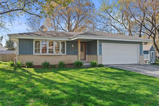ranch-style house with an attached garage, a front lawn, and brick siding