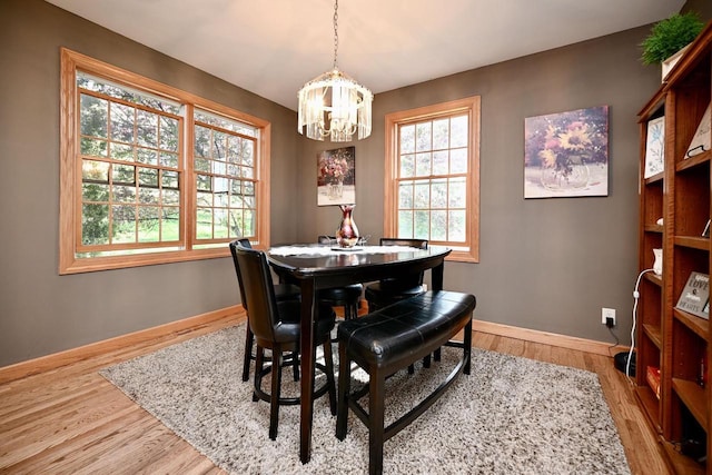 W157 Thomas Rd, Fountain City, WI 54629 - dining space featuring a chandelier, wood finished floors, and baseboards