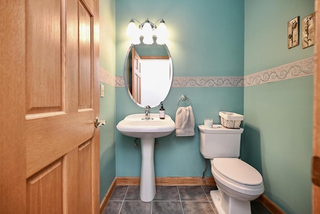 W157 Thomas Rd, Fountain City, WI 54629 - half bath with toilet, tile patterned floors, baseboards, and a sink