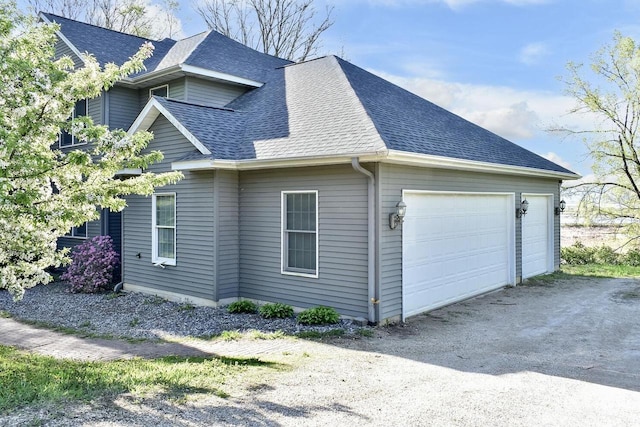 W157 Thomas Rd, Fountain City, WI 54629 - view of property exterior with roof with shingles and a garage