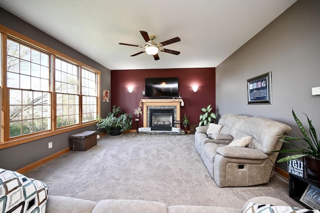 W157 Thomas Rd, Fountain City, WI 54629 - carpeted living room featuring ceiling fan, a glass covered fireplace, and baseboards