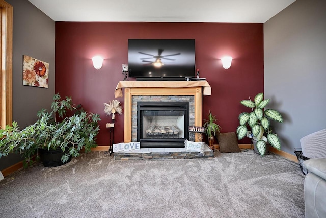 W157 Thomas Rd, Fountain City, WI 54629 - living area with a stone fireplace, carpet floors, baseboards, a ceiling fan, and an accent wall