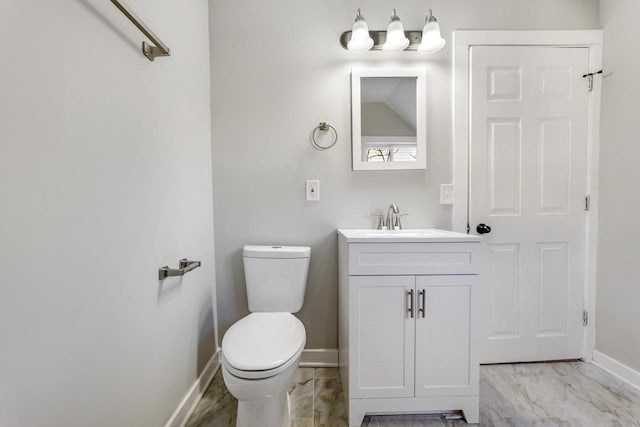 bathroom with vanity, toilet, baseboards, and marble finish floor