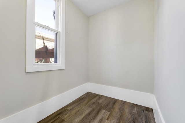 unfurnished room with dark wood-style flooring