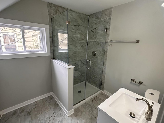 full bath with vanity, baseboards, a shower stall, and marble finish floor