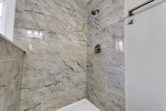 bathroom with tiled shower