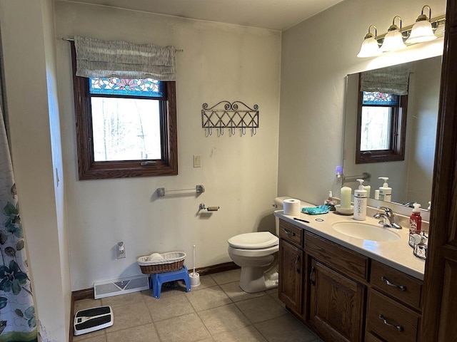 bathroom with toilet, tile patterned floors, visible vents, baseboards, and vanity