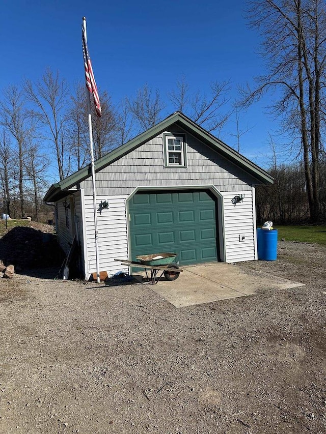 garage with dirt driveway