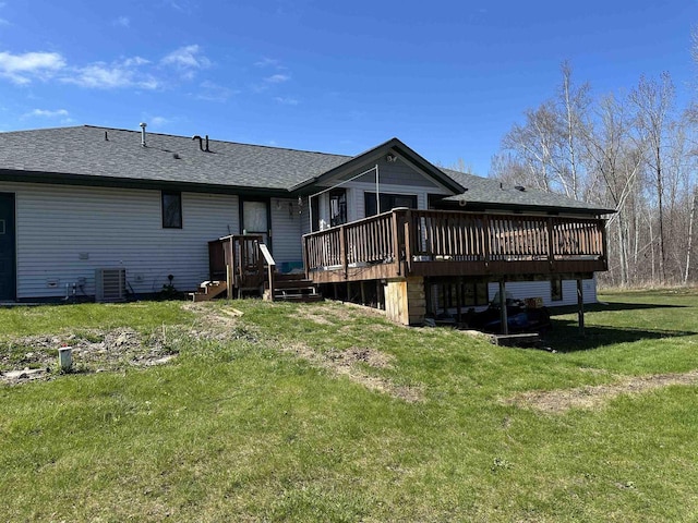 back of property featuring a shingled roof, central AC unit, a deck, and a lawn