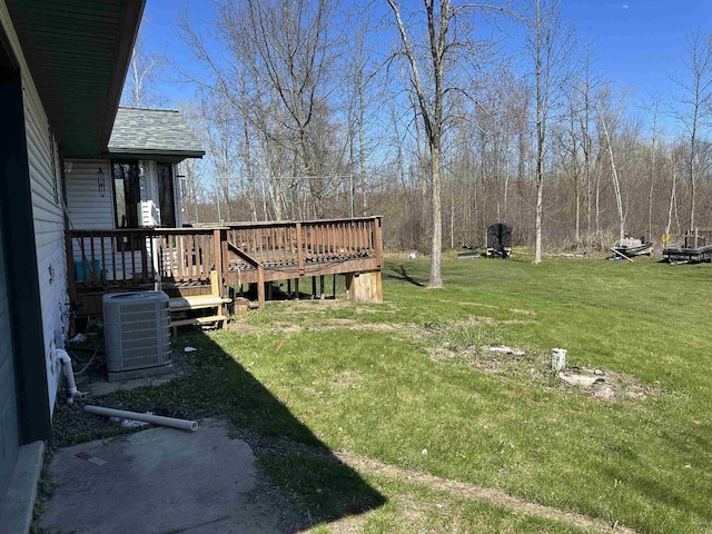 view of yard featuring central air condition unit and a wooden deck