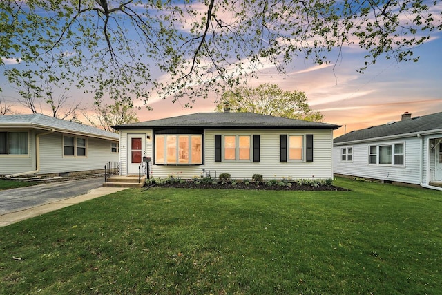 ranch-style house with a front lawn