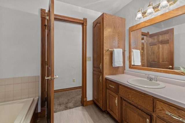 bathroom with vanity and a tub to relax in