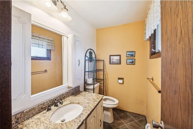 bathroom featuring vanity, toilet, and tile patterned floors