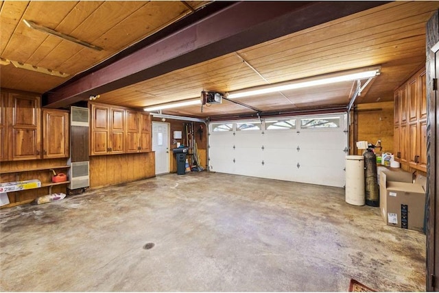 garage with wooden ceiling and a garage door opener