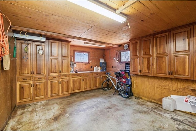 interior space featuring wood ceiling and concrete flooring