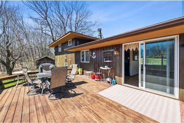 wooden deck featuring outdoor dining space