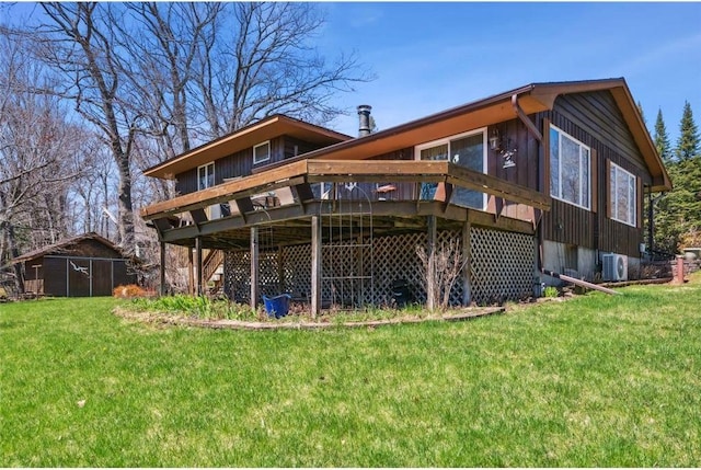 rear view of property featuring a yard, a deck, and ac unit