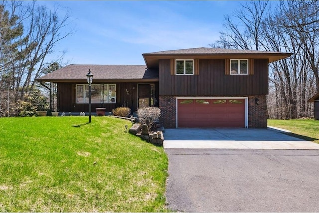 split level home with an attached garage, brick siding, driveway, and a front lawn