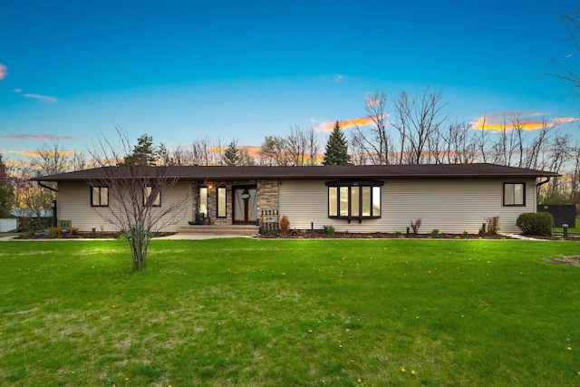 back of property featuring a yard