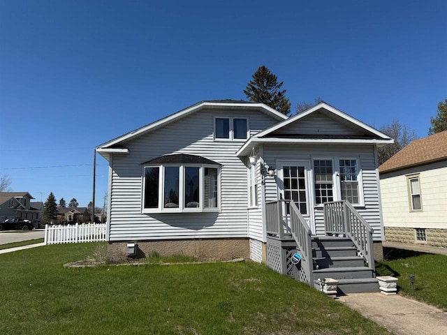 bungalow-style home with a front yard, fence, and crawl space