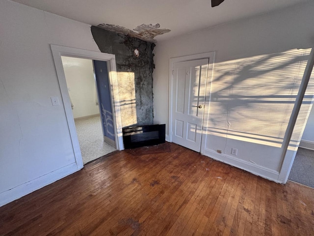 unfurnished dining area with baseboards and hardwood / wood-style floors