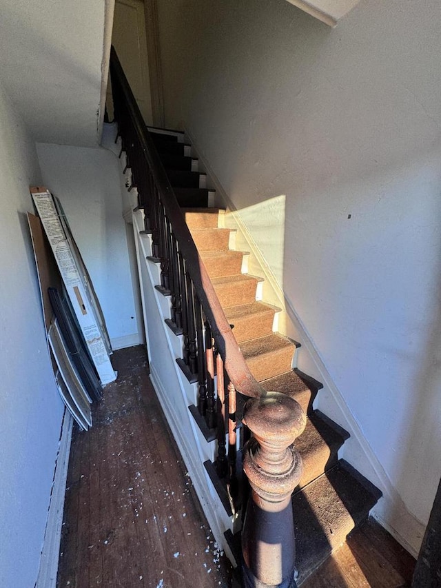 staircase with baseboards and hardwood / wood-style floors