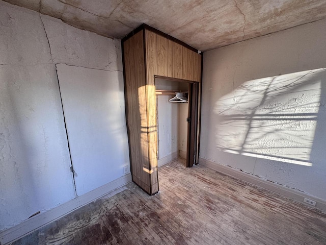 interior space with a closet and wood finished floors