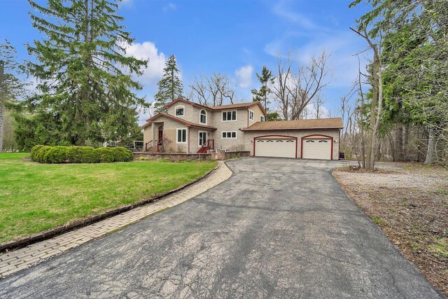 8408 N Lake Dr, Fox Point, WI 53217 - view of front facade with a front lawn, aphalt driveway, and an attached garage