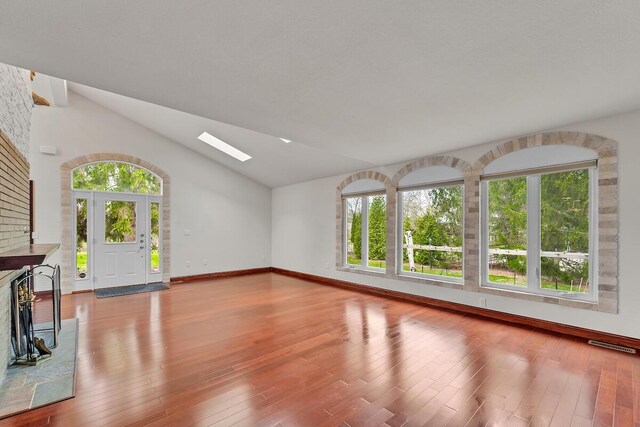 8408 N Lake Dr, Fox Point, WI 53217 - unfurnished living room featuring wood-type flooring, baseboards, and a healthy amount of sunlight
