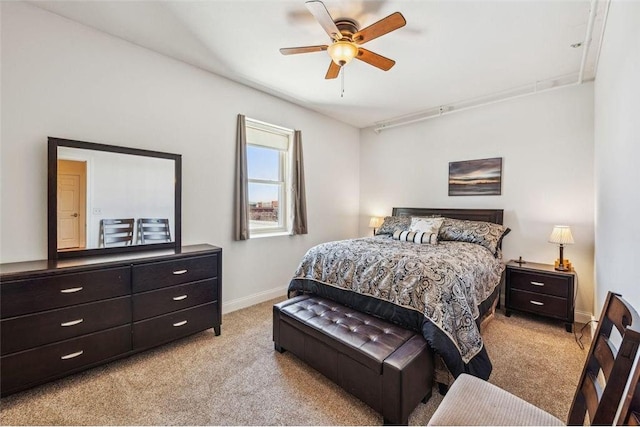 bedroom featuring baseboards, light carpet, and a ceiling fan