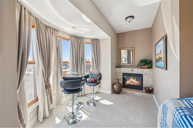 bedroom featuring a fireplace, carpet, and baseboards