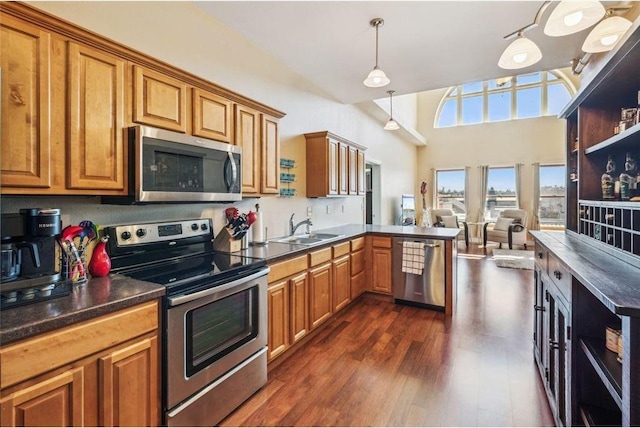 kitchen with a sink, brown cabinetry, and appliances with stainless steel finishes
