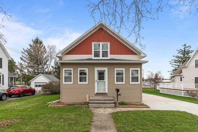 bungalow-style house with a front yard and entry steps